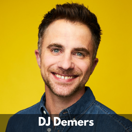 DJ Demers is a white man in his 30s. He has short brown hair with a touch of grey at the sides, a moustache, short beard and a beaming smile. He wears a blue denim button up shirt matching his blue eyes.